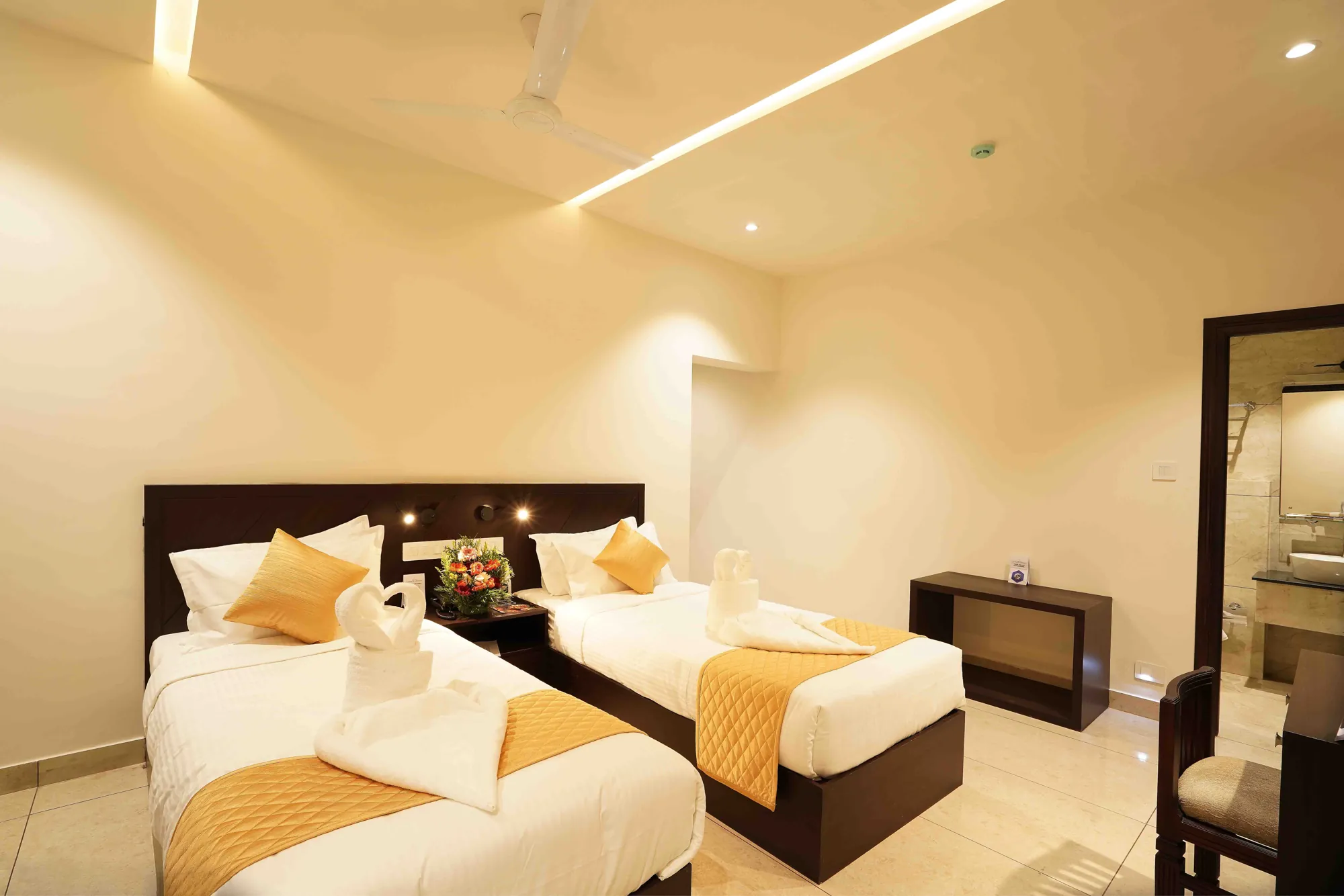 Deluxe Non-AC Room with two single beds and gold quilted runners