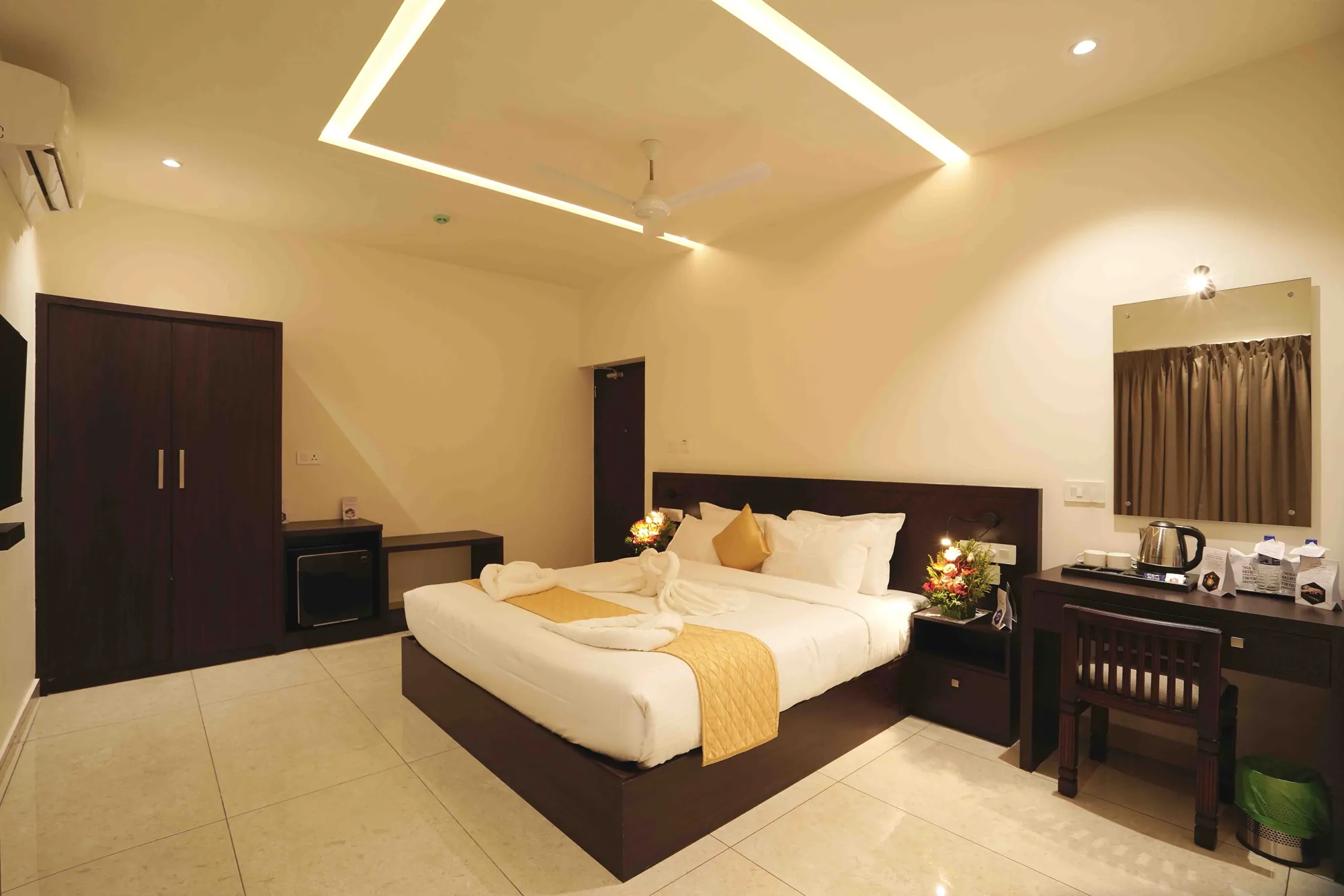 A deluxe double room beneath a softly lit ceiling