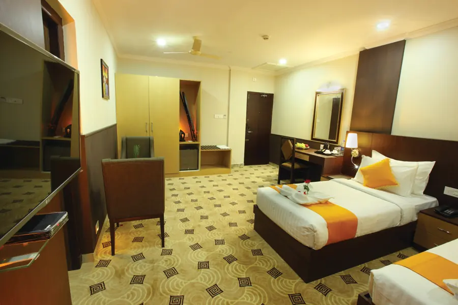 Twin room with wardrobe and armchair